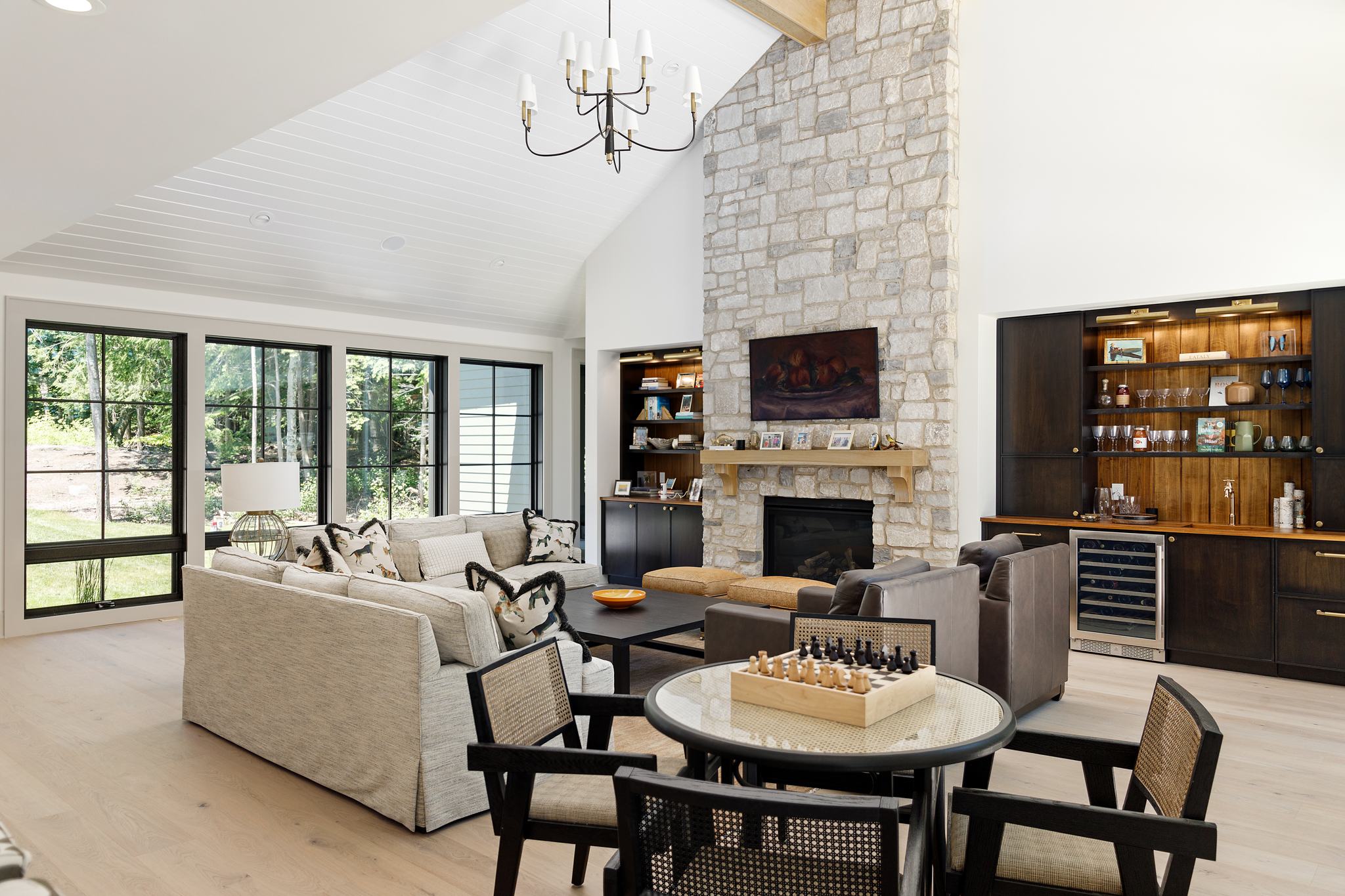 Living room with vaulted ceiling, stone fireplace and built-ins