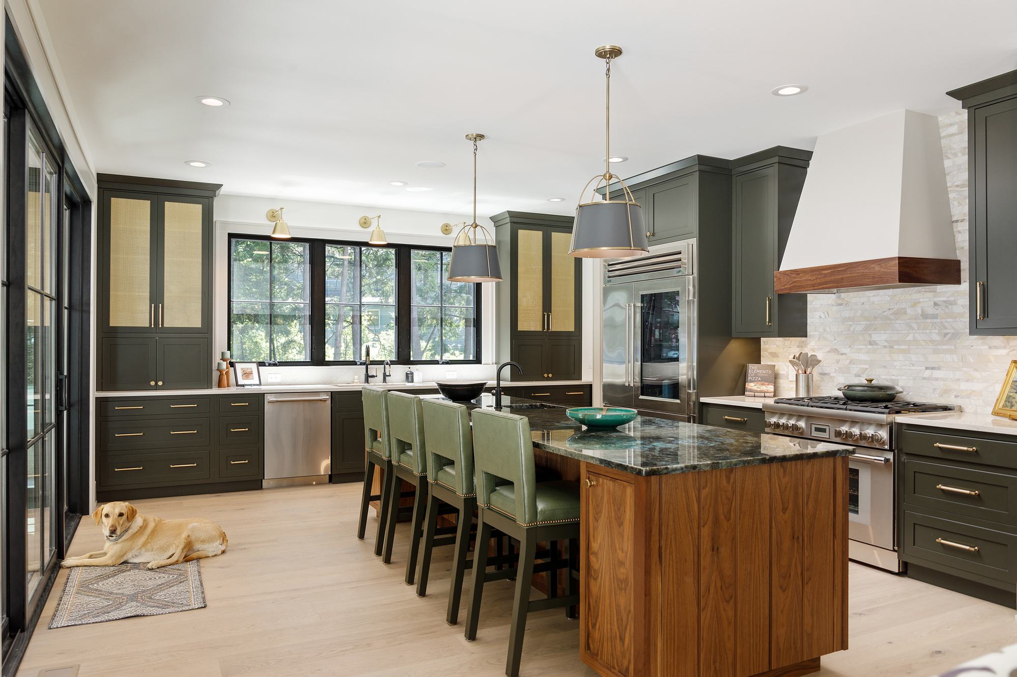 Kitchen with green cabinetry, walnut island and range hood