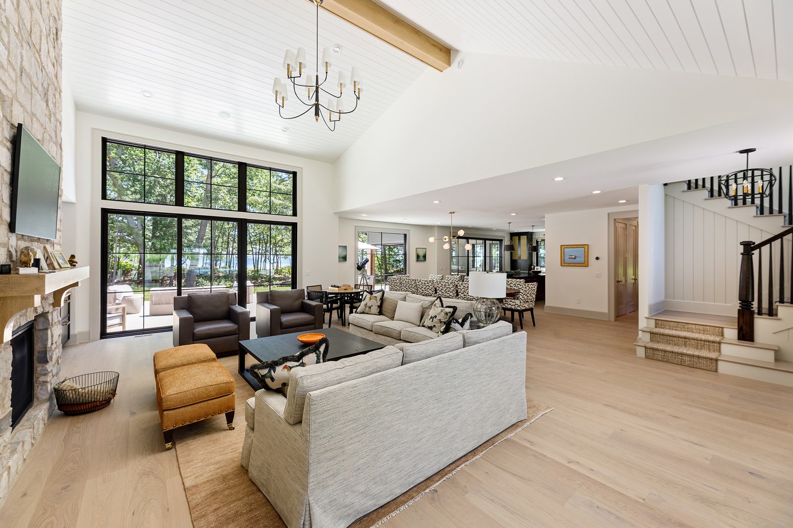 Open living room with vaulted ceiling and stone fireplace
