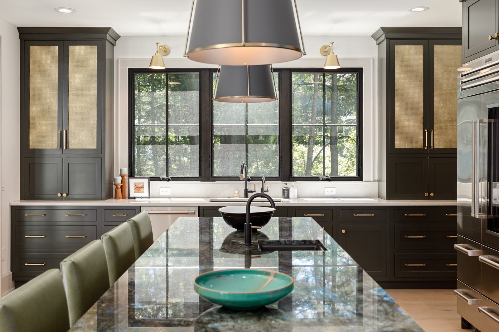 Kitchen with green cabinetry and a stone-topped island